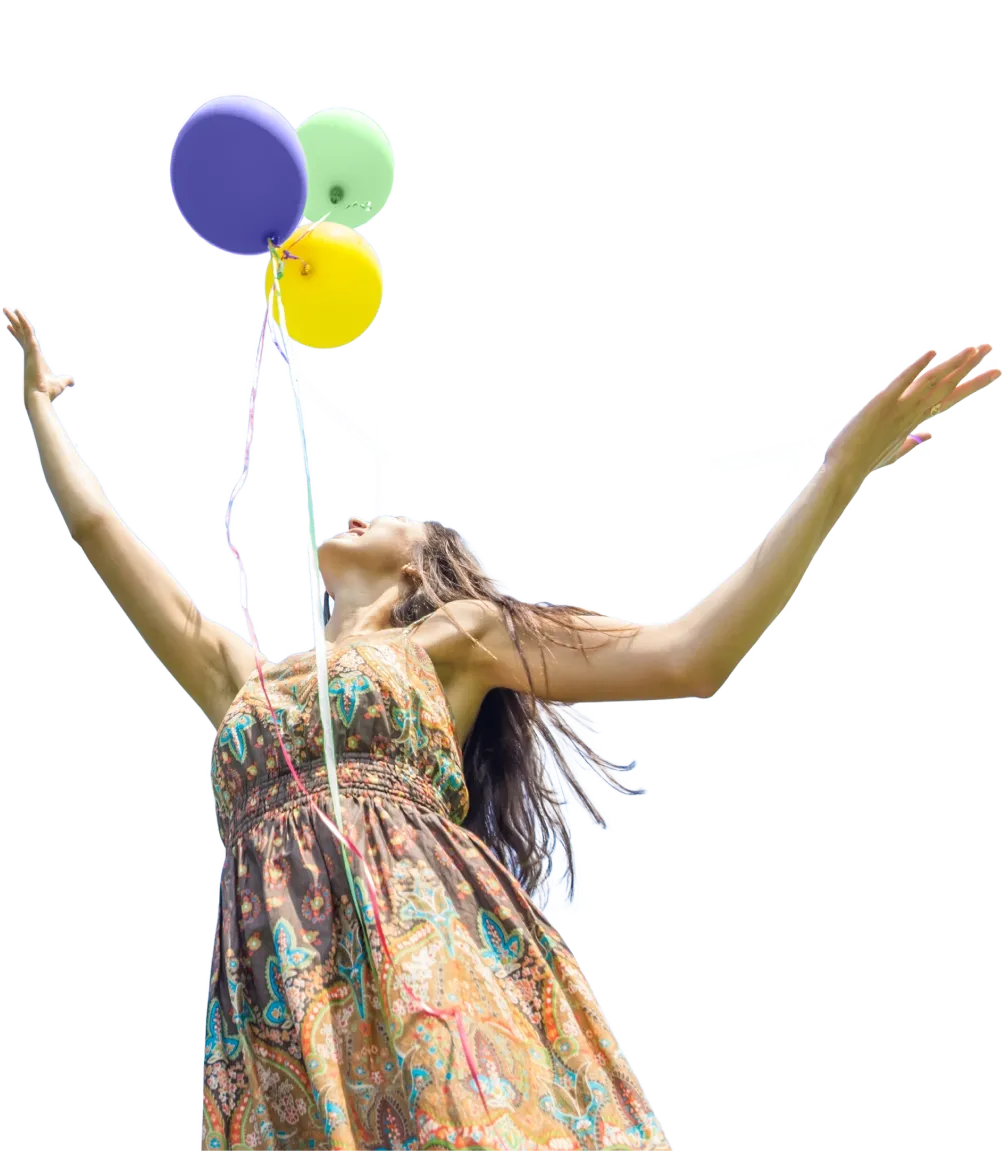 A woman in a dress letting go of colorful balloons